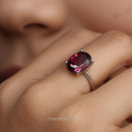 Artisanal rhodolite garnet ring displayed on a soft textured background