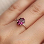 Elegant oval rhodolite garnet ring highlighting the gemstone’s facets and rich color