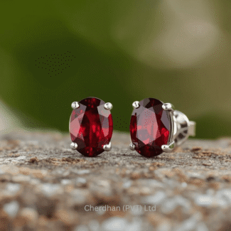 Elegant round-cut garnet stud earrings with silver setting