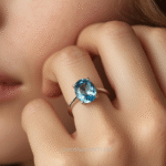 Woman wearing a solitaire blue topaz ring highlighting the gemstone and silver shine