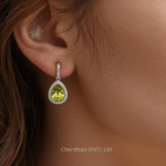 Lifestyle photo of a woman wearing elegant, dangling green peridot drop earrings with her hair up, perfect for an evening event or party.