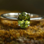 Close-up of a natural peridot ring set in polished 925 sterling silver with a vibrant green gemstone.