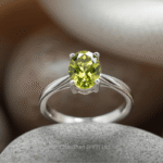 Woman wearing a sterling silver peridot ring highlighting the gemstone’s natural glow.