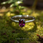 Woman wearing a handcrafted rhodolite garnet ring showing natural beauty and shine